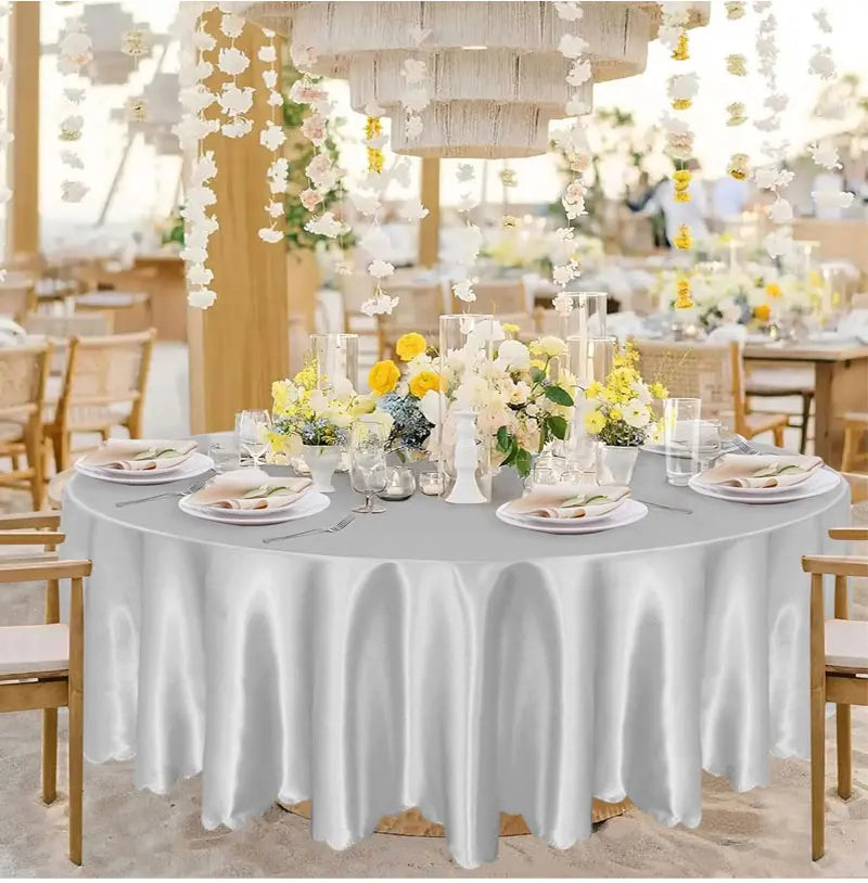 Elegant satin white round tablecloth set for weddings and events with floral decor