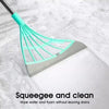 A silicone squeegee broom with a teal head and handle is shown cleaning a white surface.