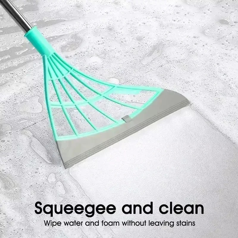 A silicone squeegee broom with a teal head and handle is shown cleaning a white surface.