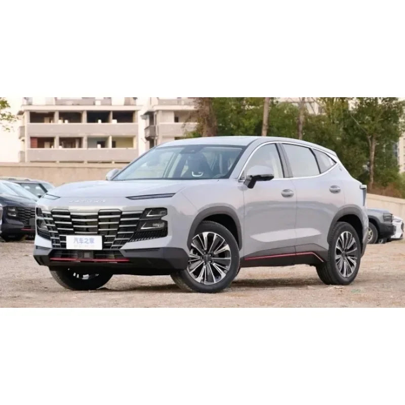 A silver SUV is shown outdoors, parked in front of a modern building.