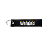 Black nylon keychain with embroidered yellow stars and the word wanted