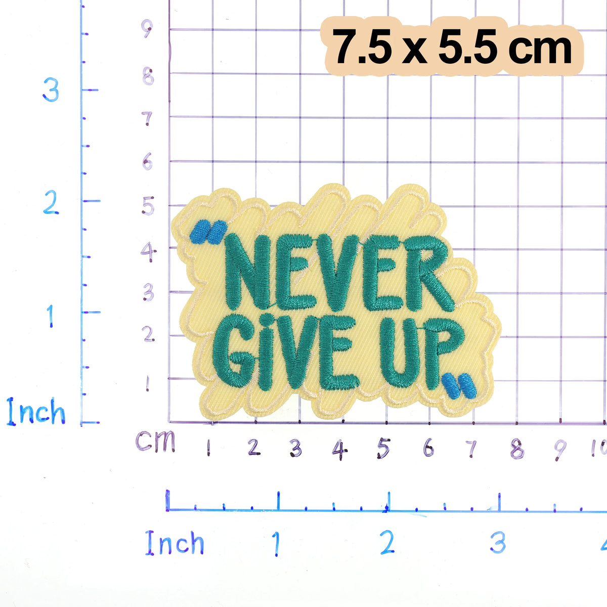 Yellow embroidered patch with teal text that reads NEVER GIVE UP on a grid background.