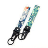 A keychain featuring a design of the Kanagawa surf wave in blue and white on a light background.