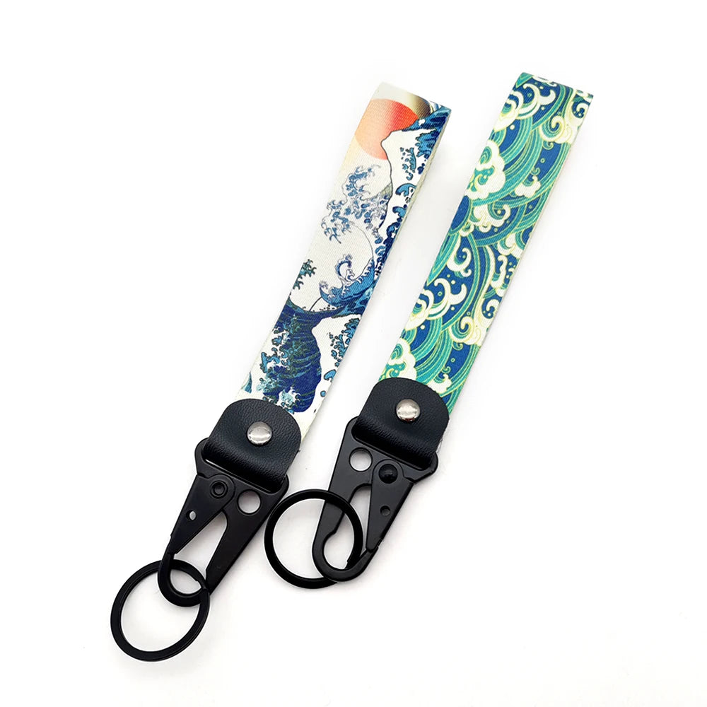 A keychain featuring a design of the Kanagawa surf wave in blue and white on a light background.