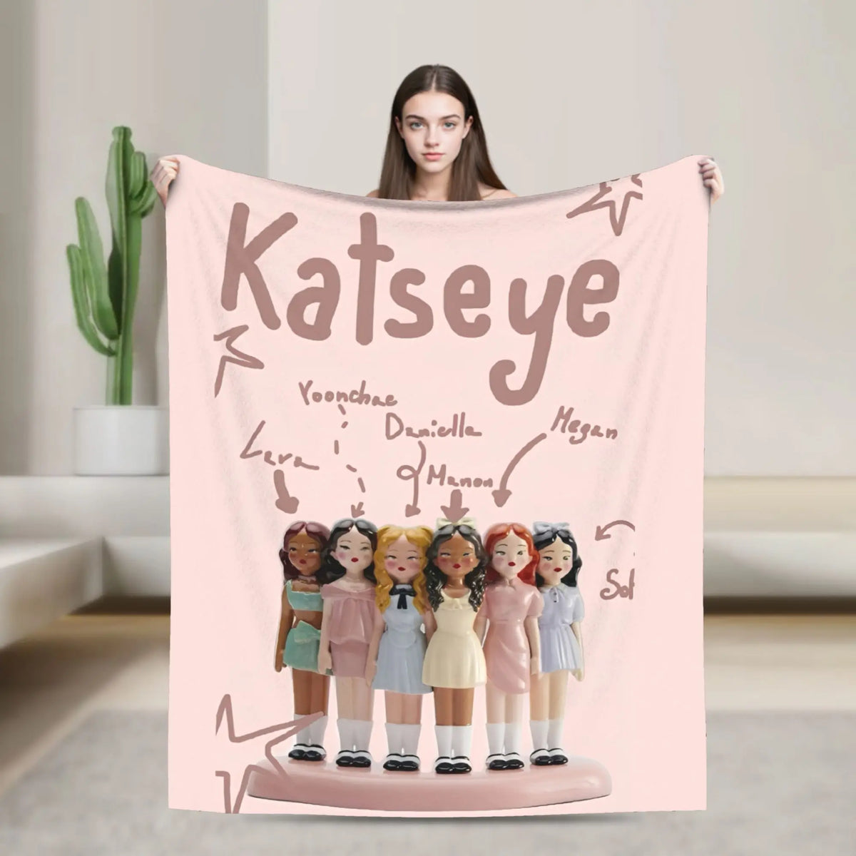A pink microfiber fleece throw blanket featuring illustrations of several young girls.