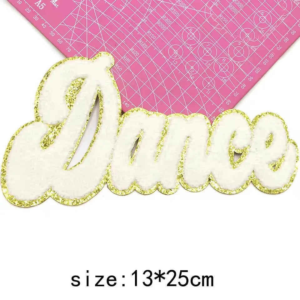 Large white chenille letter patch spelling Dance with gold glitter outline