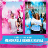 A group of women celebrating a gender reveal with pink and blue colored powder in a vibrant setting.