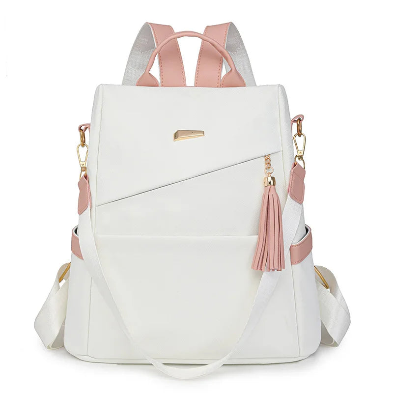 A white vegan leather backpack with pink accents and a laptop compartment.