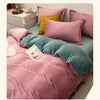 A pink flannel duvet cover with a zipper and various accent pillows on a bed.