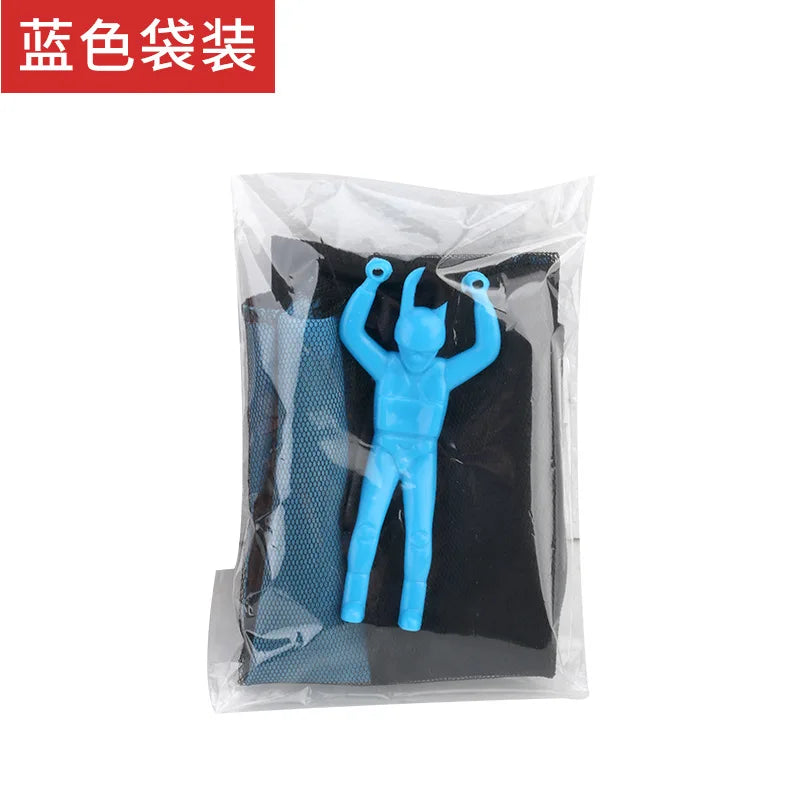 A blue hand-throw parachute toy with a mini soldier figure inside a clear plastic bag.