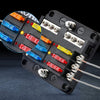 Black storage box containing an assortment of blade fuses with various colored plastic bodies and metal terminals.