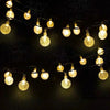 String lights with warm yellow bulbs are strung across a dark background, resembling falling stars.