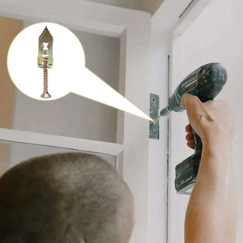 A hand uses a drill to install a heavy duty self-drilling drywall anchor into a wall opening.