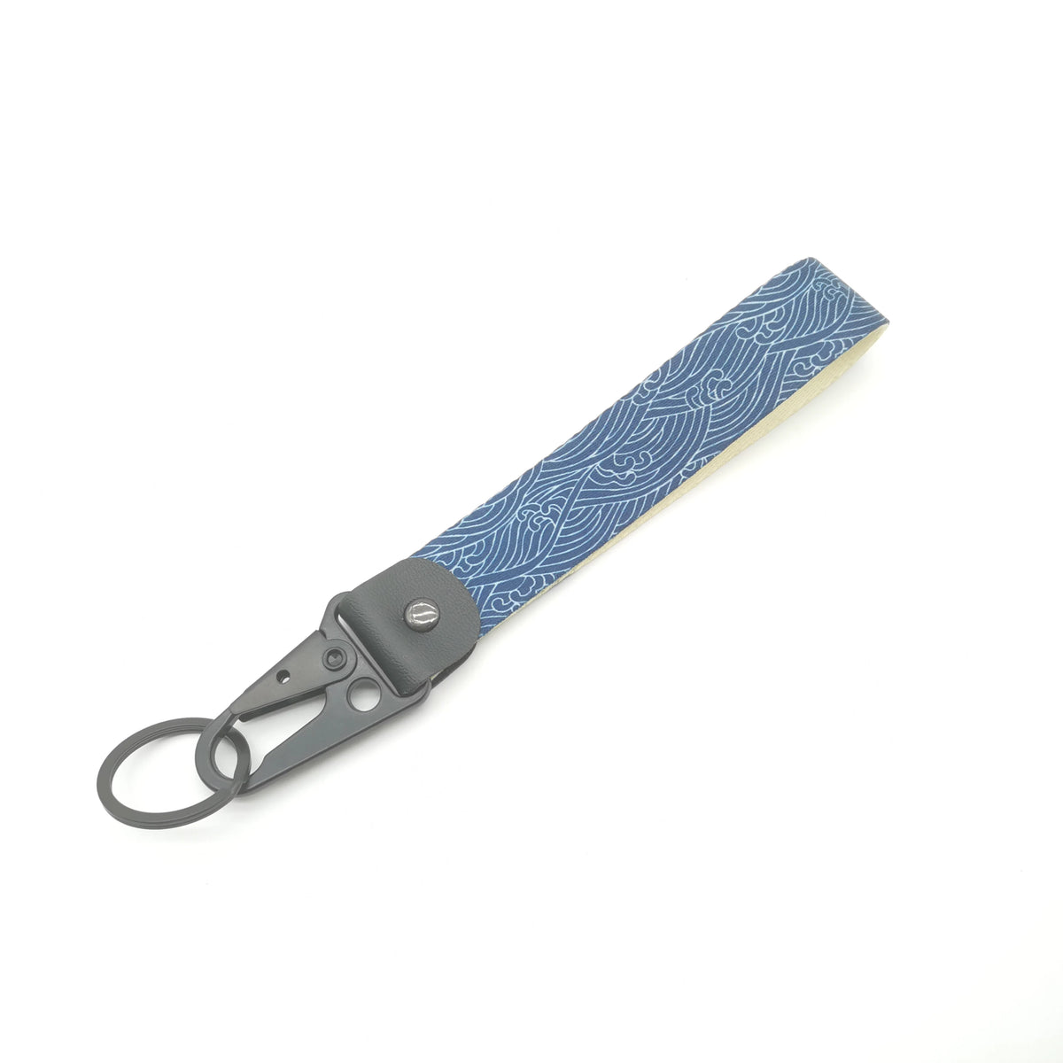 A gray keychain featuring a blue and white Kanagawa surf design on a wooden-look strap.