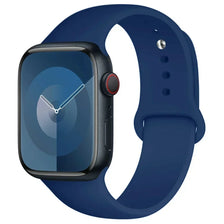 A dark blue silicone sport band for an Apple Watch shown next to the watch.