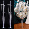 Two clear plastic balloon column stands displayed against a dark background.