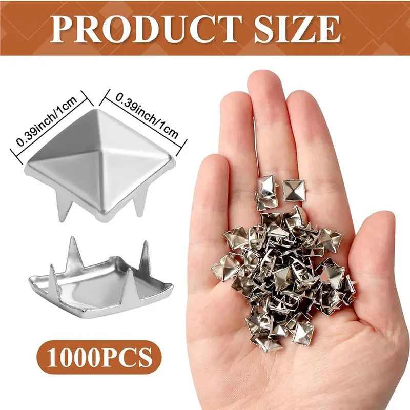 A hand holds a pile of silver metal pyramid studs with four prongs for DIY fashion projects.