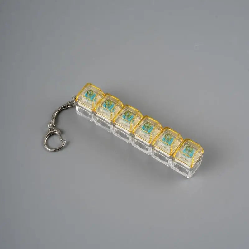 A clear acrylic keychain featuring multiple small, colorful LED mechanical fidget toys.