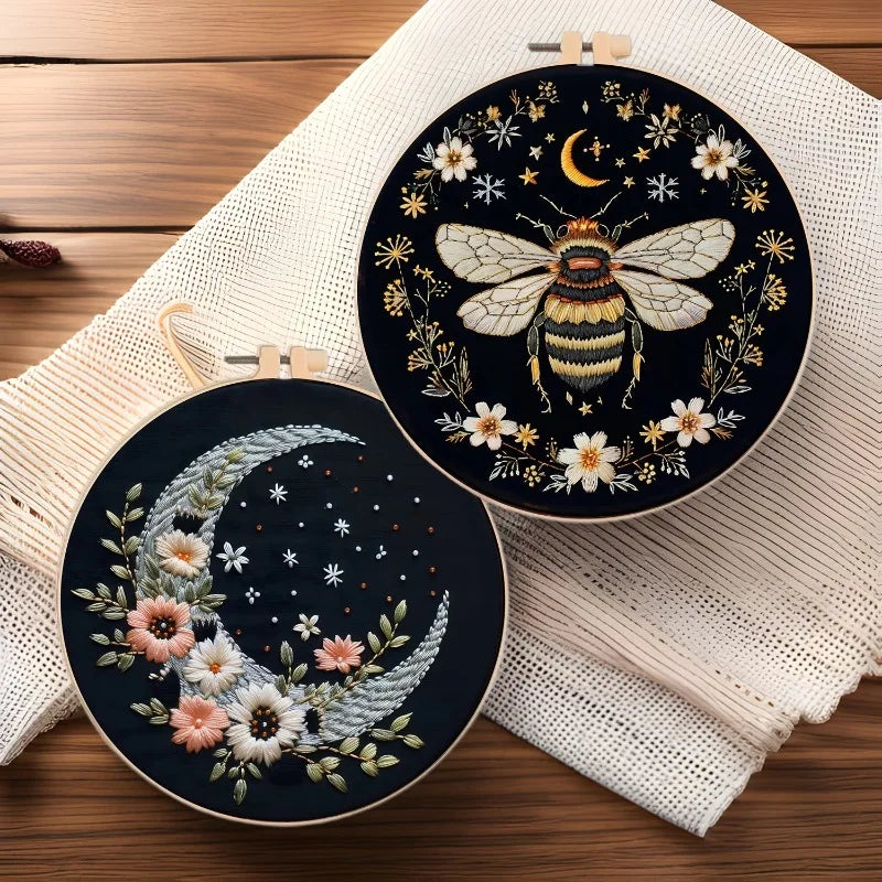 DIY embroidery kit featuring a golden butterfly and silver moon design on a dark fabric