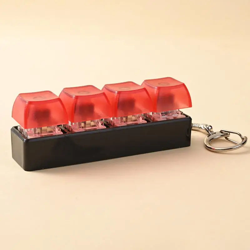 A black LED mechanical keychain fidget toy featuring multiple translucent red keycaps.