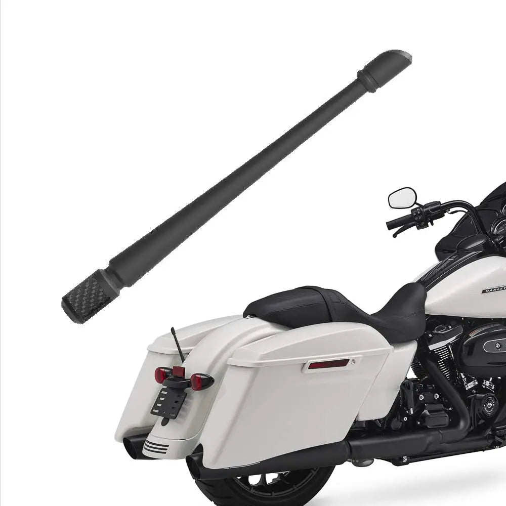 A black universal car radio antenna is shown mounted on a white motorcycle.