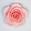 A soft pink rose bloom silicone mold used for decorating chocolates, candy, and fondant.