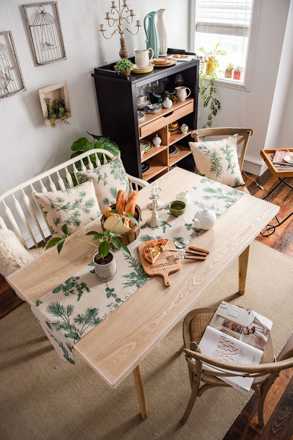 A light green and white gingham table runner is displayed on a wooden dining table with natural decor.