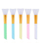 Five silicone facial mask brushes with gold handles and pastel colored silicone tips.