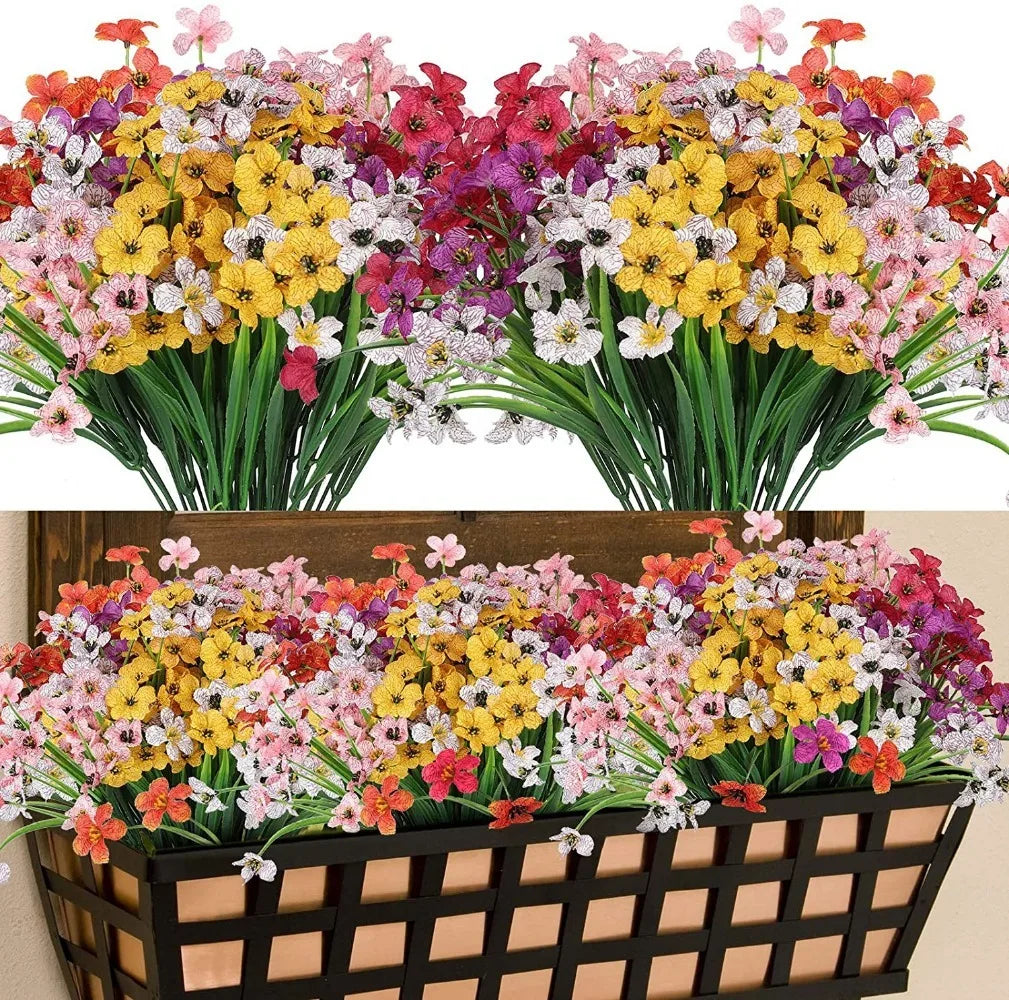 Un vibrante ramo de narcisos artificiales con flores rosas, amarillas y moradas, exhibido en una caja de madera.