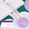A white adjustable circular paper cutter with a purple blade and two interchangeable parts resting on a green cutting mat.