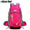 A bright pink hiking backpack with gray accents and a yellow climbing rope visible inside.