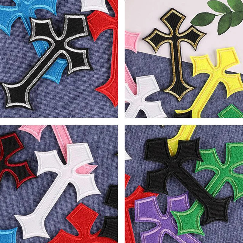 A collection of ten vibrant embroidered cross patches in various colors including black, red, yellow, green, and purple on de