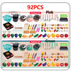 A set of 92 pieces of pink and green kids pretend play kitchen cooking utensils including pots pans and various food items