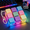 A colorful LED macaron keyboard fidget toy in a clear case with various pastel colored silicone macarons.