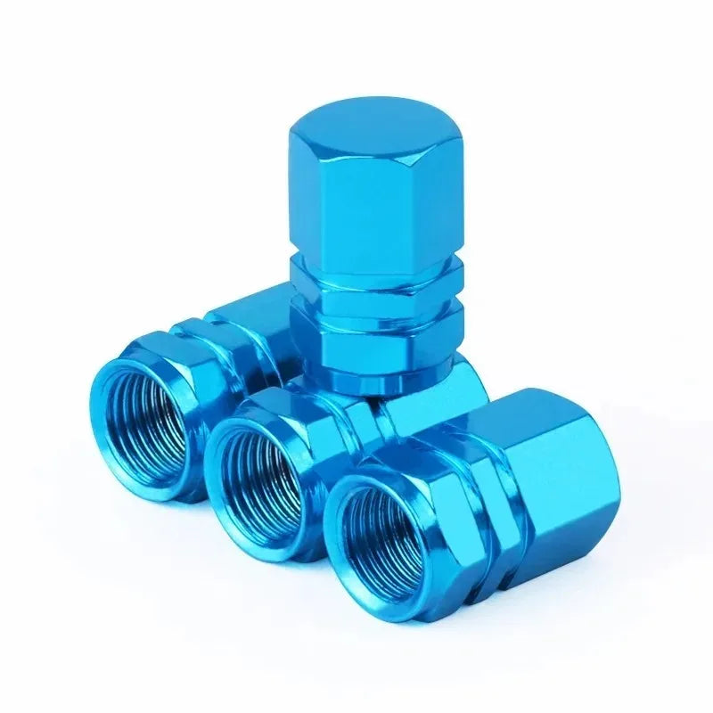 A set of bright blue aluminum alloy tire valve caps for vehicles.