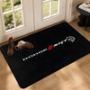 A black anti-slip doormat featuring the Dodge SRT logo and shoe silhouette on a wooden floor.