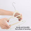 Hands holding a light beige velvet hanger with a wire hook, demonstrating its sturdy and durable bending capability.