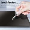 A hand is placing a silver key onto a dark tablet surface, demonstrating scratch resistance.