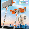 A pair of orange and gray scrub synchronization window cleaning tools with extension handles shown against a cityscape backgr