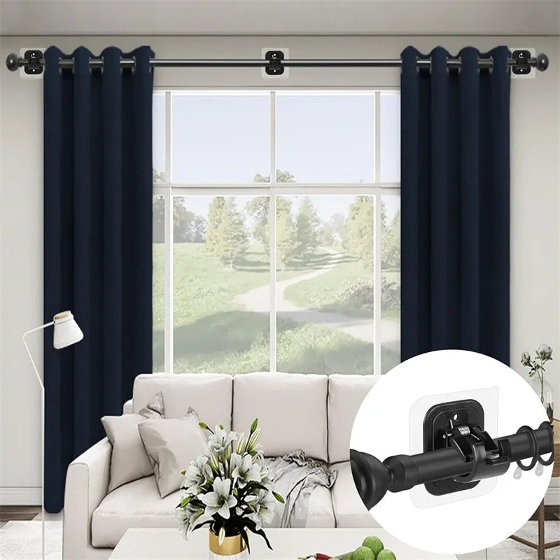 A set of two self-adhesive no-drill curtain rod brackets used to hang dark blue curtains on a window.