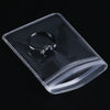 A clear PVC jewelry pouch with a zip lock closure containing a silver ring and a diamond ring.