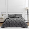 A gray queen comfort bedding set featuring a quilted comforter and pillowcases on a bed.