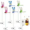 A collection of lifelike dragonfly garden decor clips in various colors and sizes, suspended by thin wires.