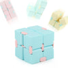 A set of light blue and pink Infinity Magic Cube fidget toys arranged in various configurations.