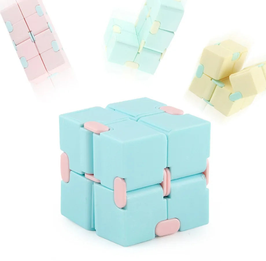 A set of light blue and pink Infinity Magic Cube fidget toys arranged in various configurations.