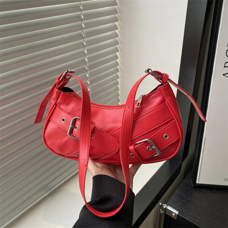 A bright red Y2K vintage PU leather crossbody bag being held by a person.