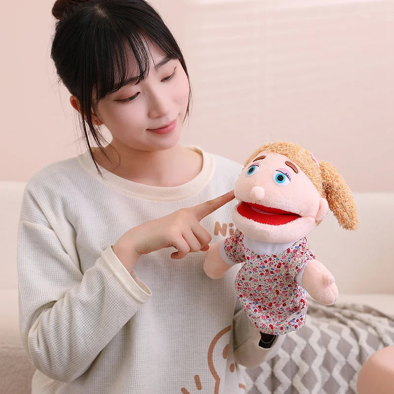 A woman points at a soft plush hand puppet for kids, demonstrating interactive role-play.