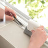 A hand is using a multi-purpose crevice cleaning brush to clean window tracks.