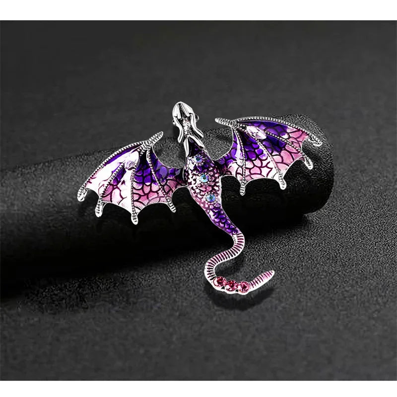 Silver enamel dragon brooch with purple and pink rhinestones shaped like a serpentine creature