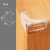 A clear silicone corner edge guard is shown resting on a wooden surface, demonstrating its shape and size.